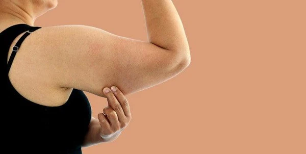 Toning Bingo Wings: Your Ultimate Guide to Sculpting Sleek Arms at the Gym 1 Woman doing push-ups for arm strength Waltham Abbey