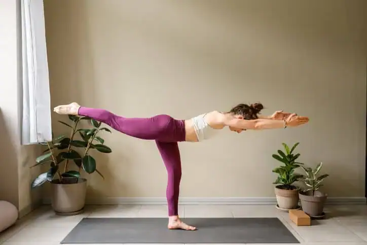 Woman doing Yoga exercise Waltham Abbey to help with toning the body. 